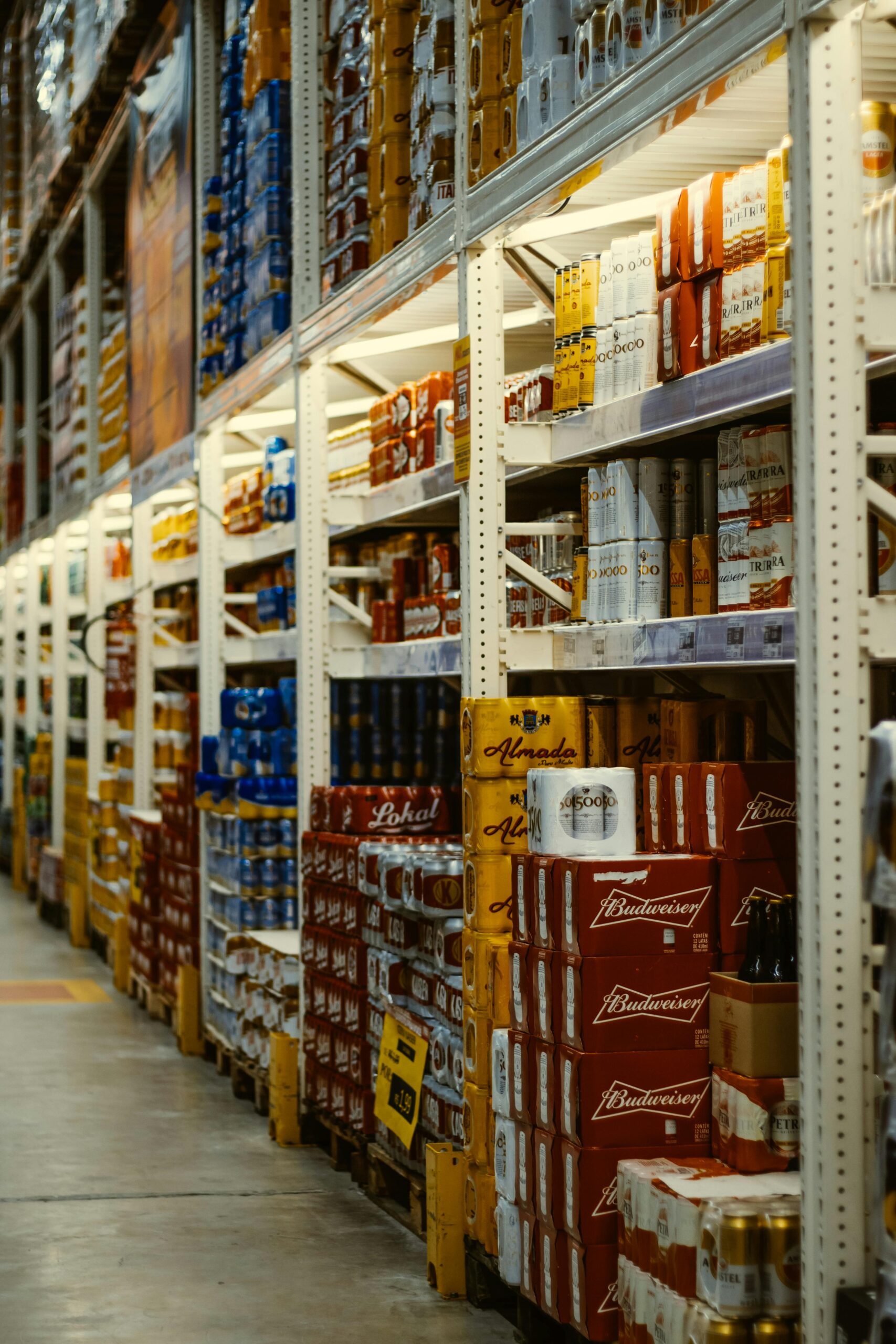 Rows of beverages on shelves in a warehouse. These dont need cold storage and can be stored without worry in a food safe warehouse.